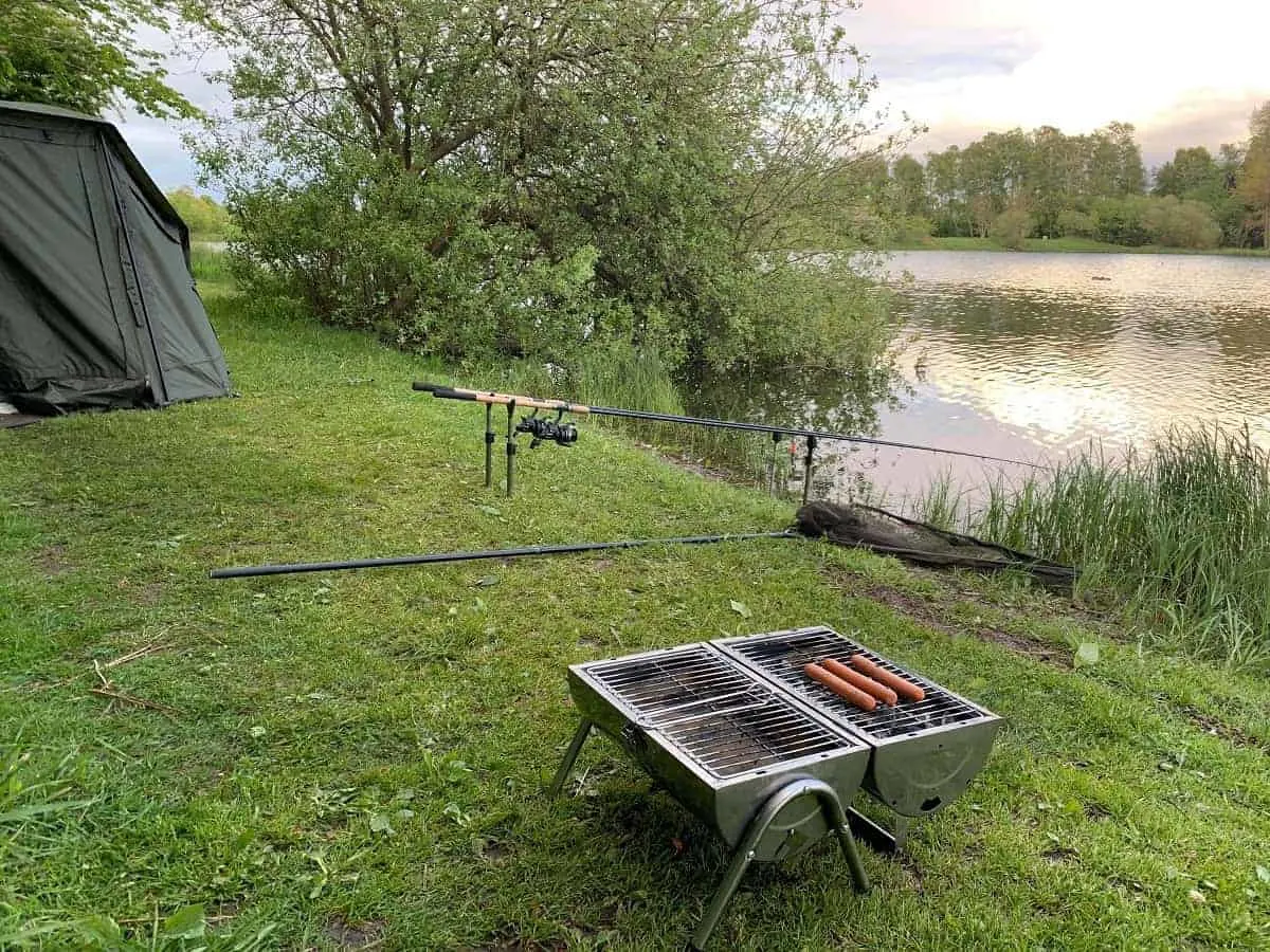 a fishing spot with a grill and some delicious suasages on it