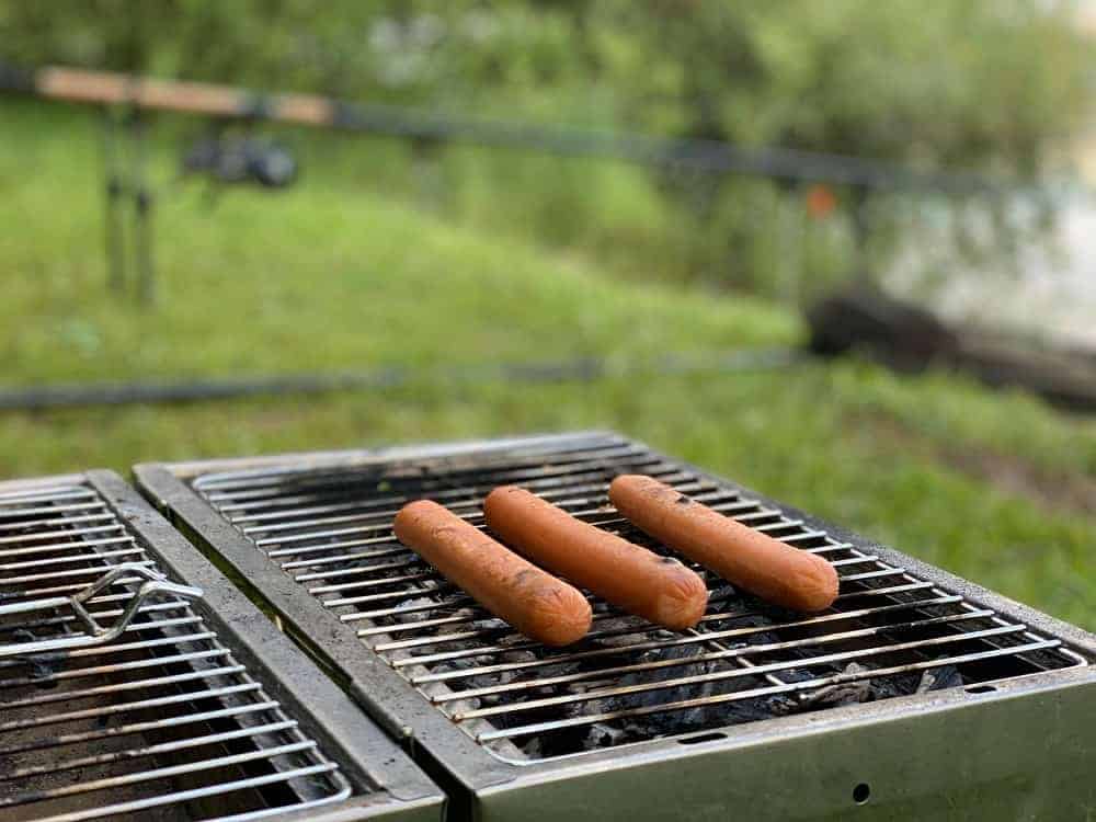 a bunch of hot dogs on a grill 