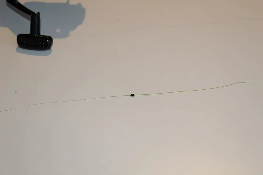 an image of a piece of fishing line with a bobber stop on it