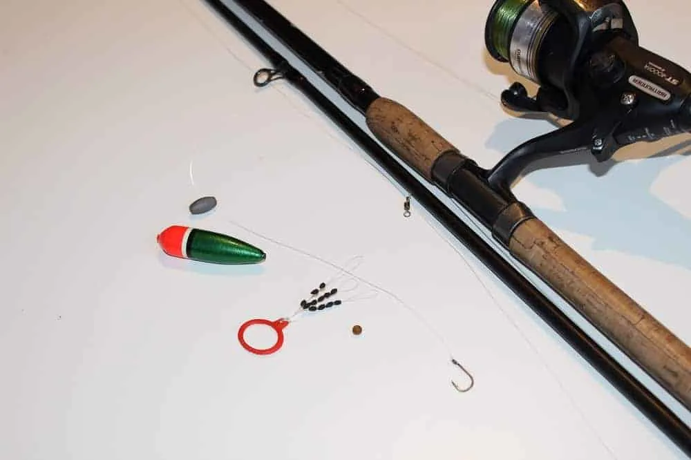 a slip bobber rig and a rod and reel displayed on a table