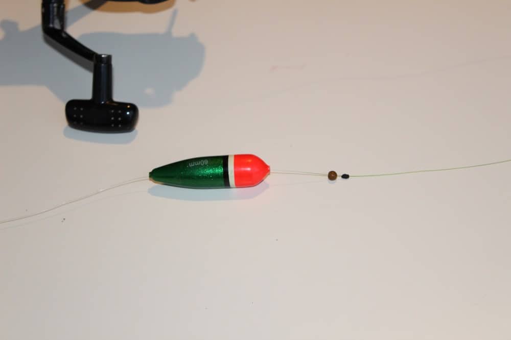 egy kép egy darab horgászzsinórról, rajta egy bobber stop, egy stop gyöngy, és egy csúszós bobber
