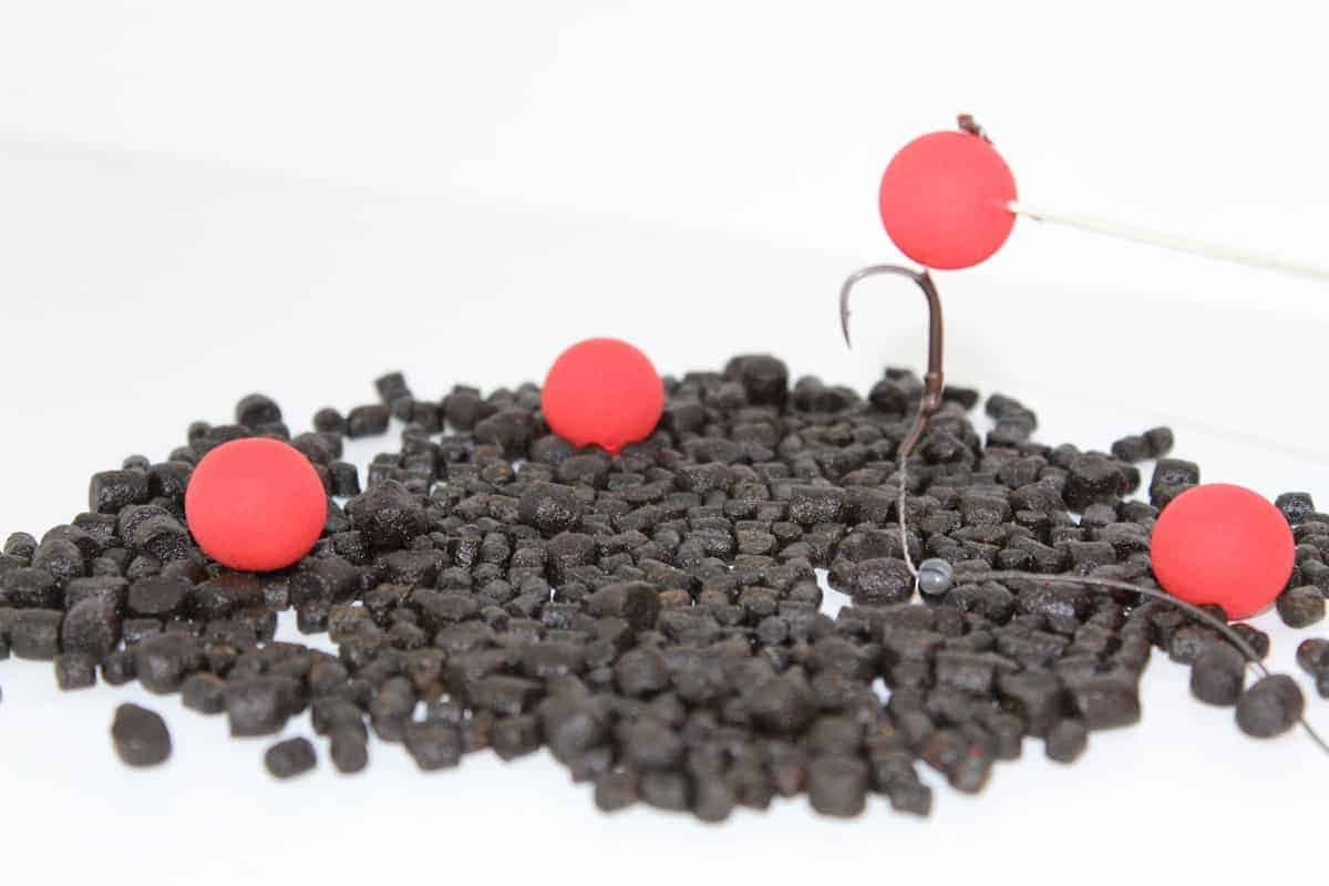 a pop-up rig with a red pop-up on a bed of pellets and red boilies for carp fishing