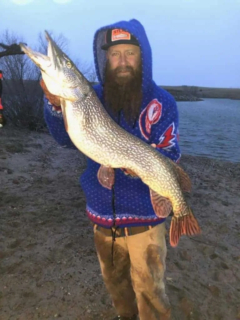 a fisherman with a beautifully colored pike
