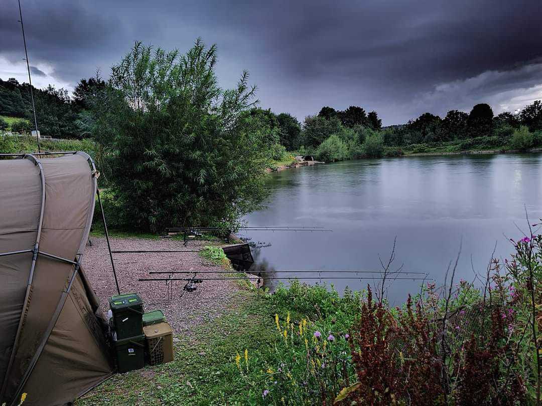 an image of a carp swim with a bivvy and cast out fishing rods