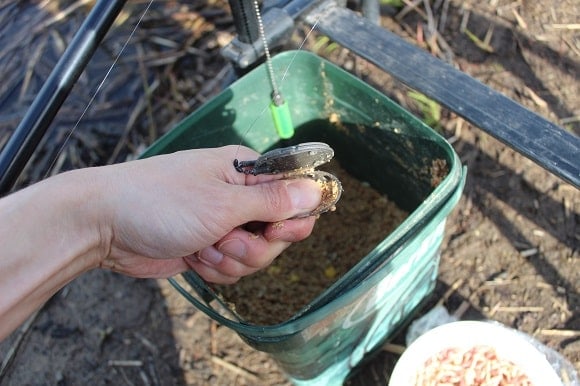 a korum feeder filled with a small portion of groundbait
