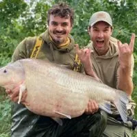 two American anglers with a giant buffalo fish caught on a lake in Texas