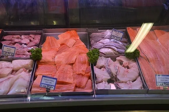 an image of different fish fillets being displayed on a fish market