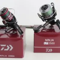 an image of two fishing reels and a fishing rod on a white table