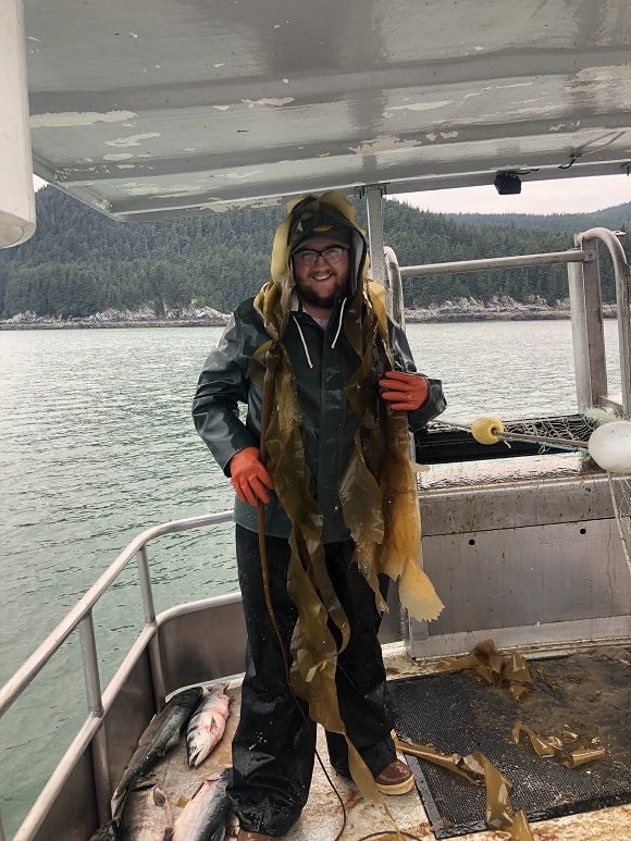 a commercial salmon fisherman on a salmon boat in Alaska