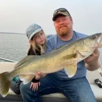 An angler and his daughter fishing for walleye on lake Saskatchewan