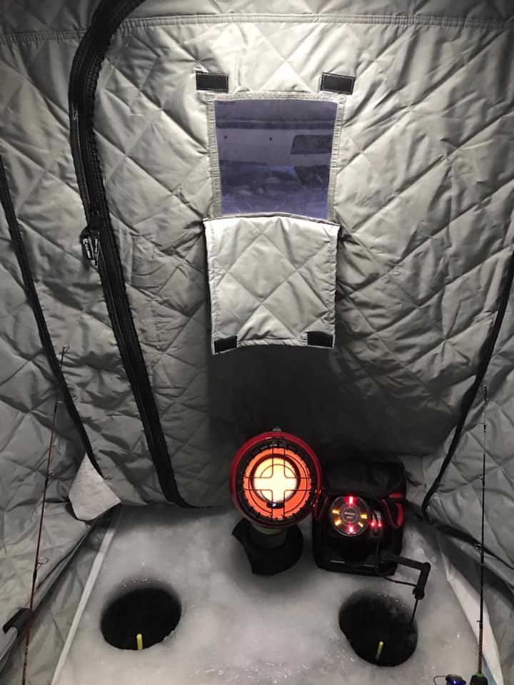 a small ice fishing pop-up shelter with a mr heater little buddy in ut