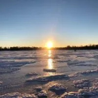 a beautiful morning on a frozen lake nipissing with a rising sun