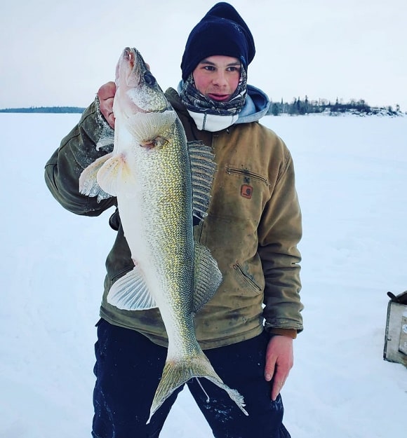 a fisherman on LOTW holding a really big walleye