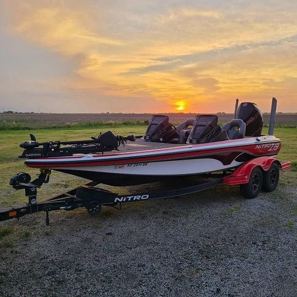 an image of a red Ntrio Z19 bass boat on its trailer