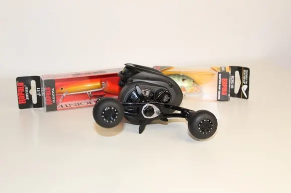 an image of the abu garcia revo beast baitcaster in front of two crankbaits