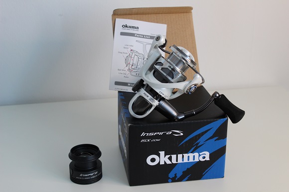 an image of an okuma spinning reel with a spare spool next to it