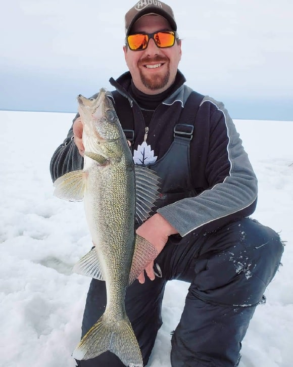 a happy ice angler with a lake nipissing ice walleye