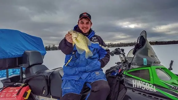 an ice angler on an ATV on Leech Lake with a fine crappie