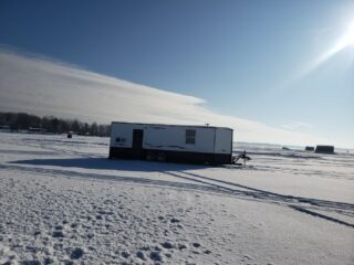 an image of an ice house on mille lacs lake in winter
