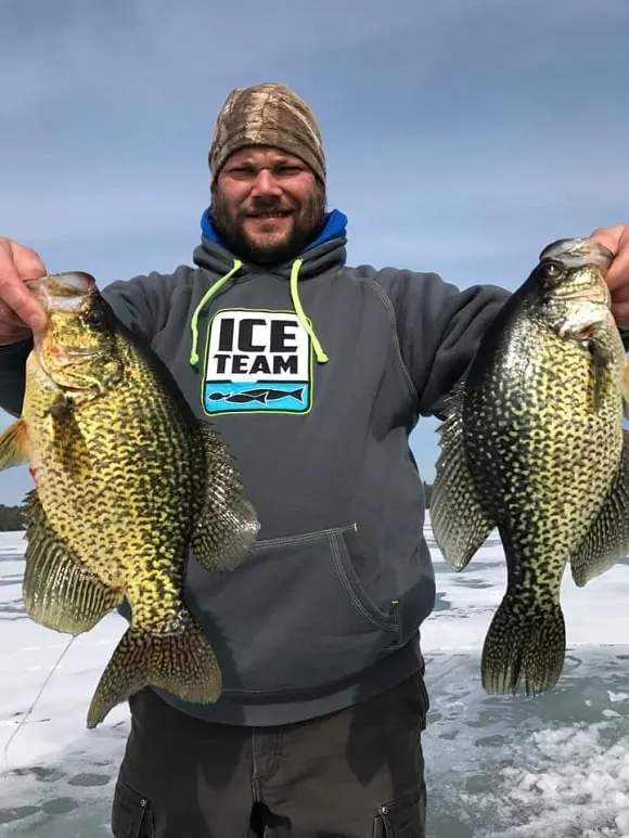 An ice angler on Mille Lacs Lake with two big crappies