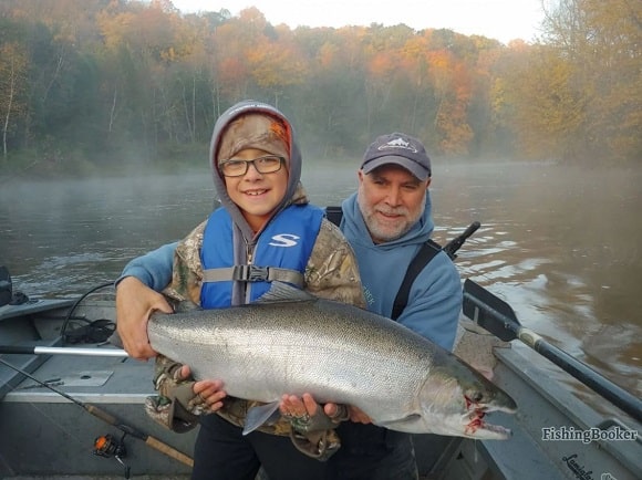 a father and his son fishing for big steelhead on the Grand River in Michigan