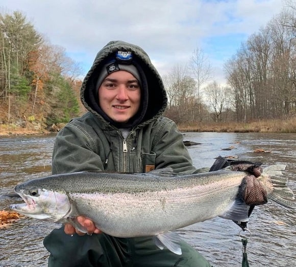 a young trout angler with a big steelhead from the Salmon River