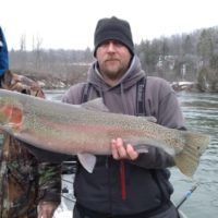 two trout anglers with a giant steelhead caught on the Manistee River in Michigan