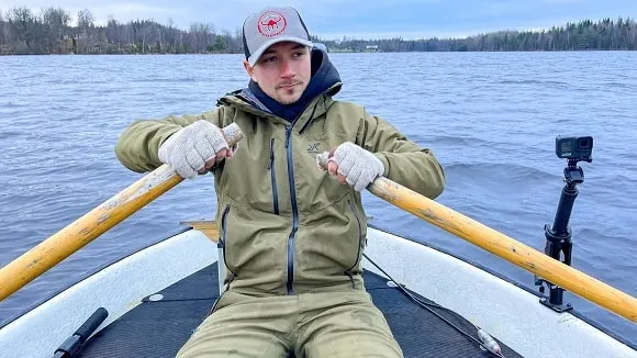 a fishing YouTuber filming with a GoPro camera on his boat