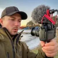 a famous fishing youtuber shooting a fishing movie with his camera