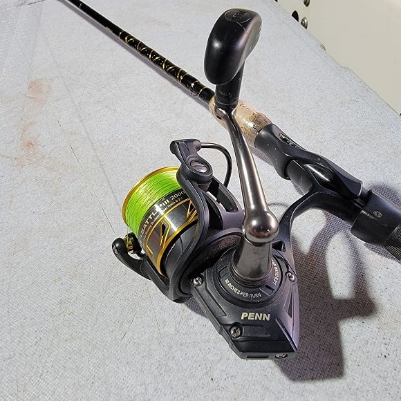 an image of a Penn Battle II spinning reel on a boat