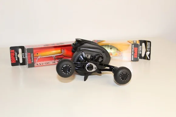 an image of an Abu Garcia Revo Beast baitcasting reel in front of two crankbaits