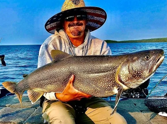 a trout angler on lake michigan with a really big lake trout