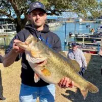 a happy bass angler with a giant largemouth bass from texas