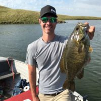 a happy bass angler with a fat pre-spawn smallmouth bass