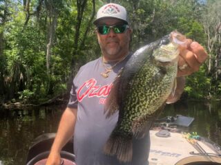 a fisher on his boat fishing for crappie in Oklahoma