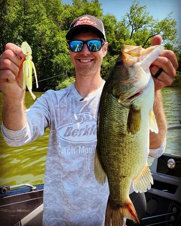a skilled bass angler on Lake Fork with a huge largemouth bass 