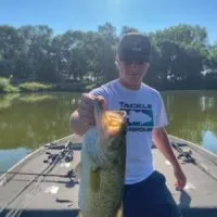a bass angler from texas holding a giant largemouth bass