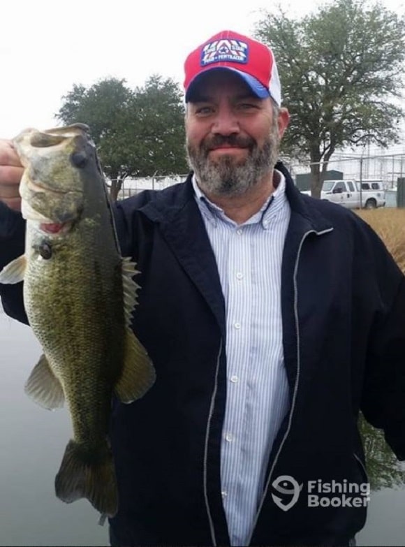 a fisher on Lake Livingston with a big bass