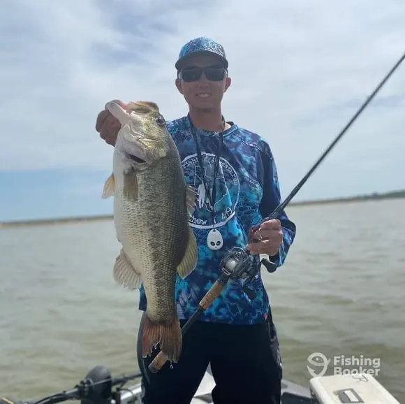 a bass angler on Lake Austin with a big spring largemouth bass