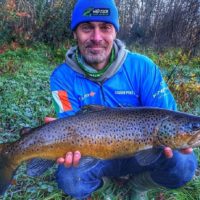 a UK angler with a huge post-spawn brown trout