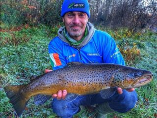 a UK angler with a huge post-spawn brown trout