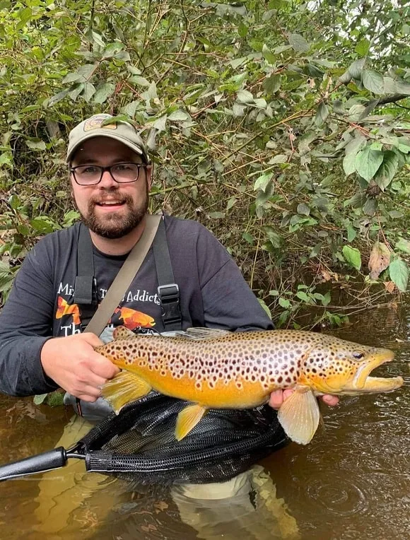 a river fisher with a gorgeous 25 inch brown trout
