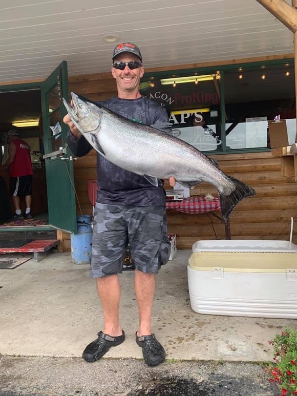 an image of an angler holding a huge king salmon caught on Puget Sound