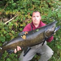 a salmon angler in Michigan holding a huge king salmon