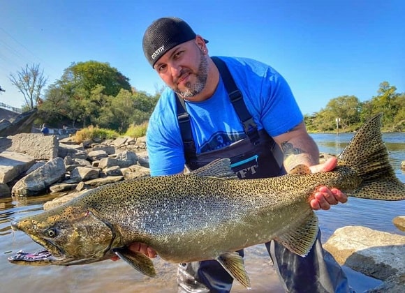 an Alaskan angler holding a big chinook salmon