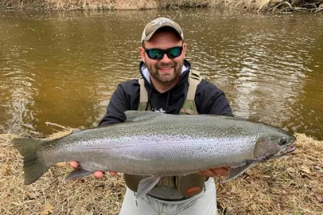 a happy Oregon trout angler with a huge steelhead