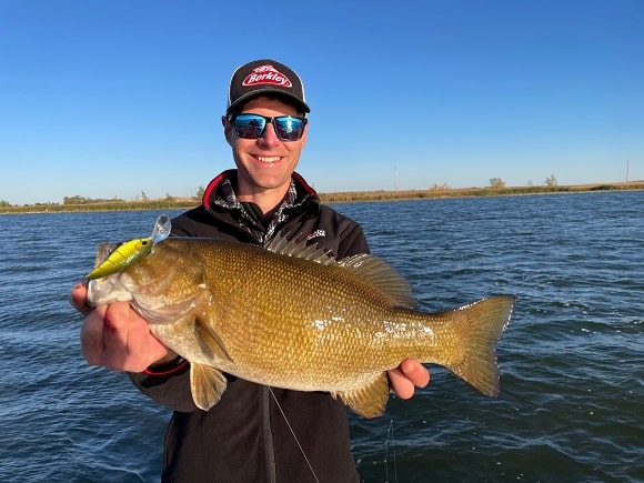 a US bass angler with a huge smallmouth bass