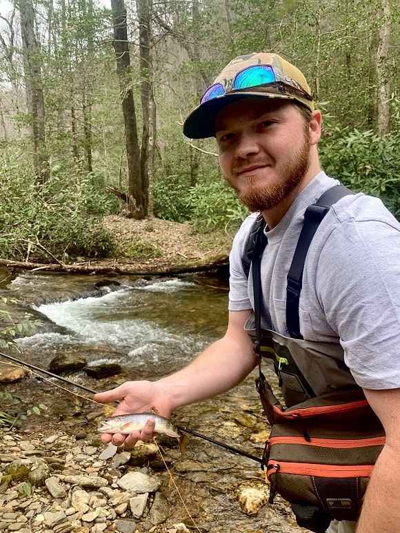 a trout angler holding a native chattahoochee river brook trout