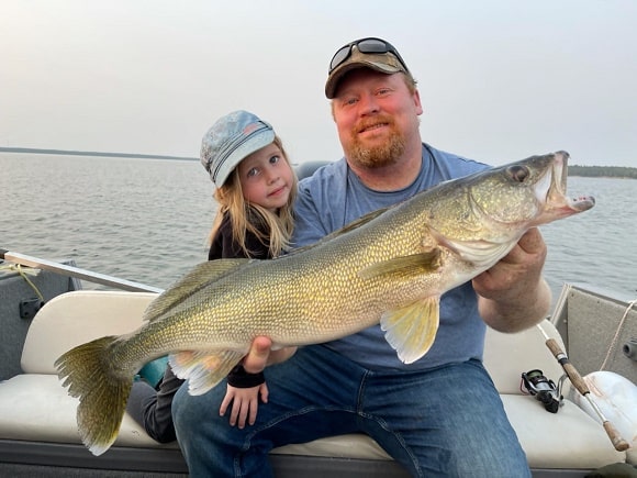 a US angler with his daughter fishing for walleye in Illinois