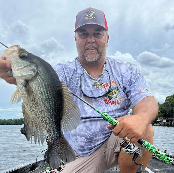 a US angler on his boat fishing for crappie just before rain